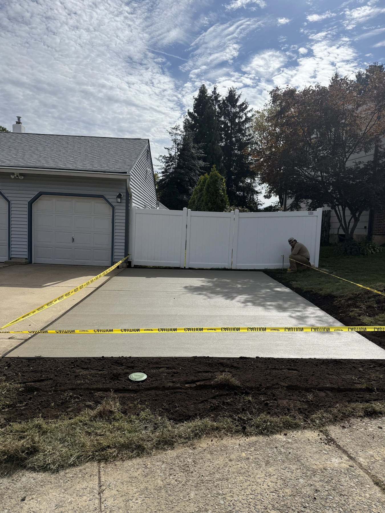 Concrete driveway section being finished by a Tri-County Construction crew in New Castle County, DE