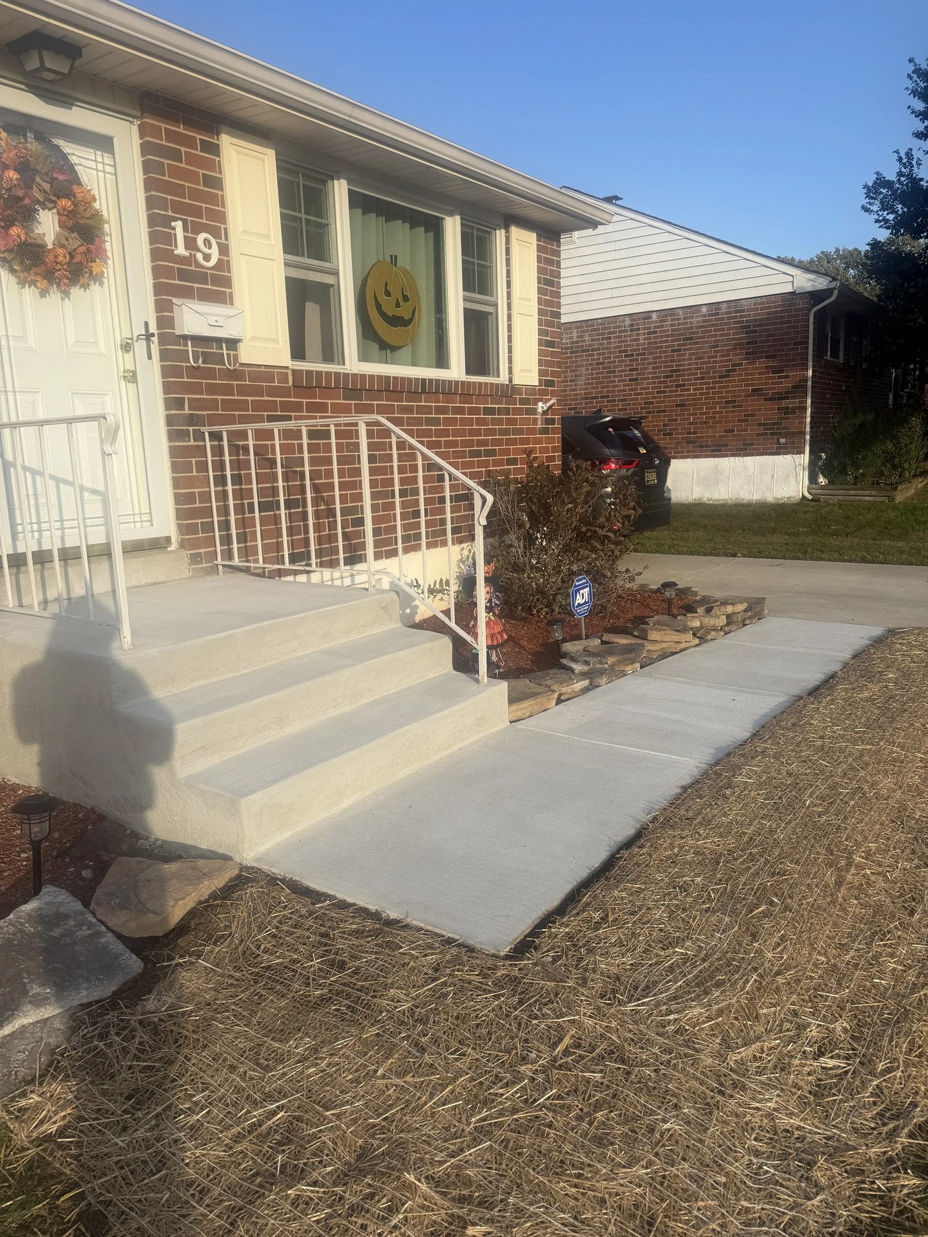 Concrete walkway and ramp leading to a brick home in Wilmington, DE