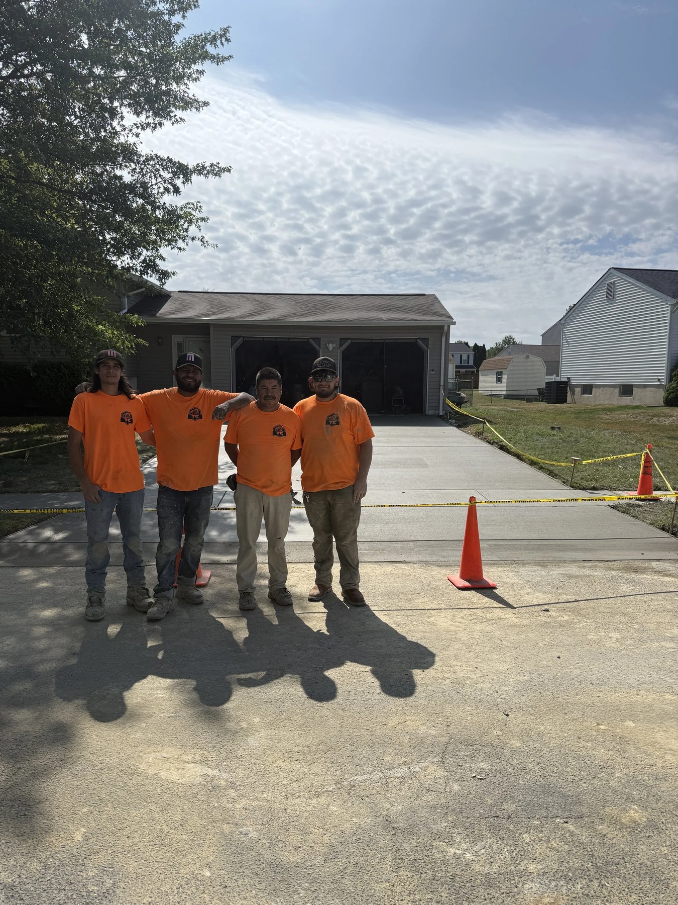 Tri-County Construction crew finishing a residential concrete driveway pour in New Castle County, DE