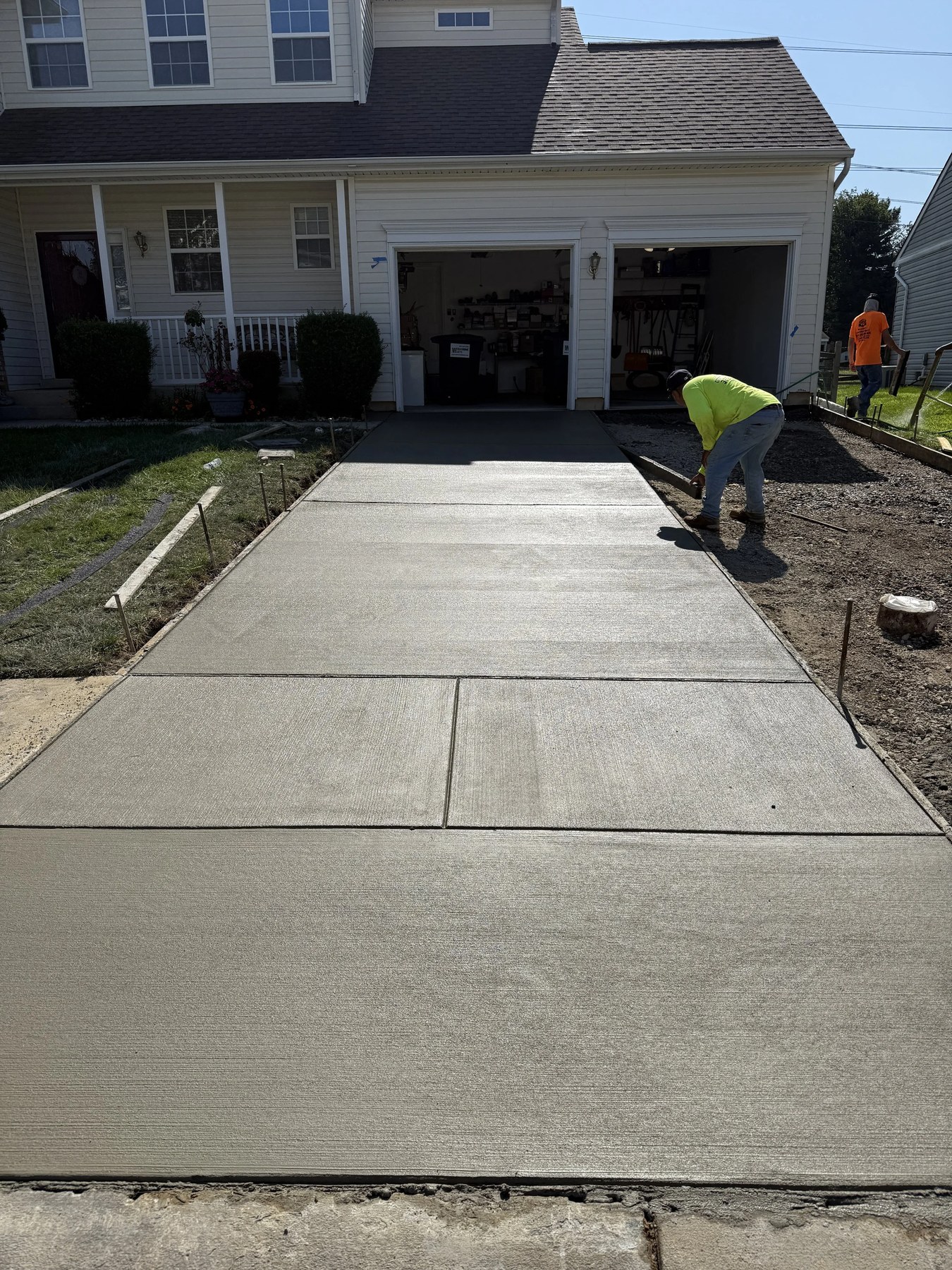 Crew pouring fresh concrete for a residential driveway in New Castle, DE