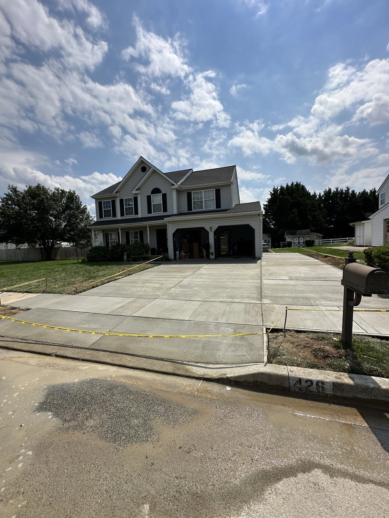 New concrete driveway installation in a residential neighborhood in New Castle County, DE
