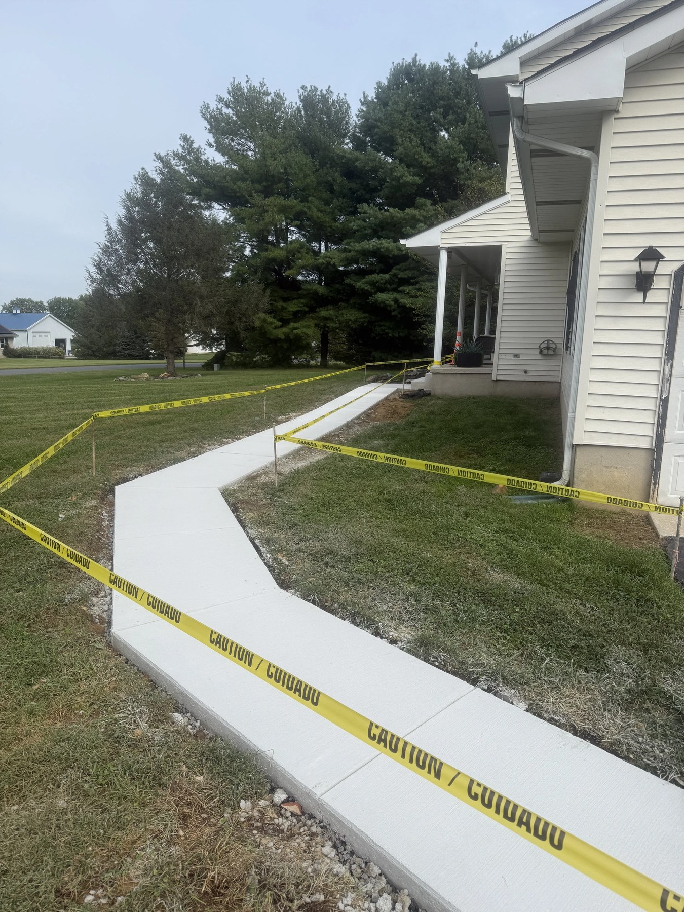 New concrete sidewalk taped off for curing outside a home in Bear, DE