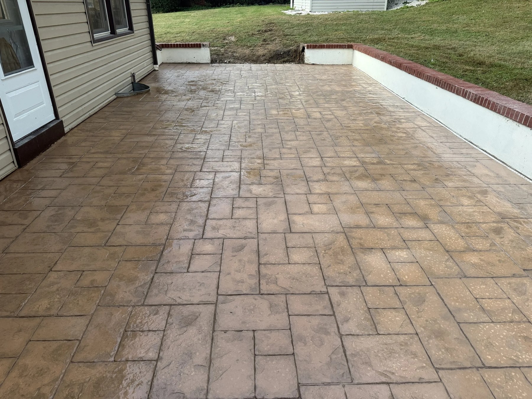 Stamped concrete patio with brick edging installed in New Castle County, DE